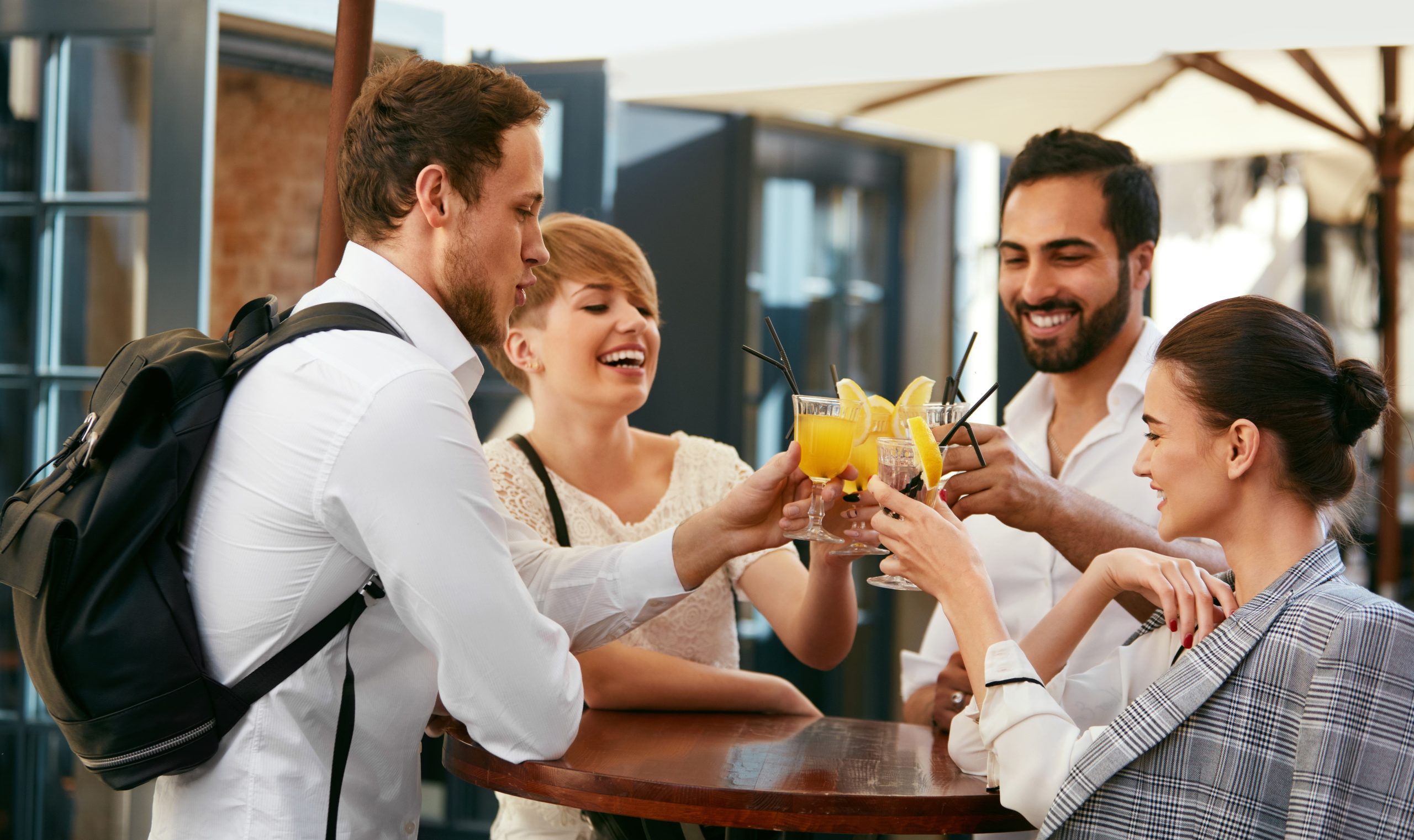 Friends Celebrating, Drinking In Bar Outdoors